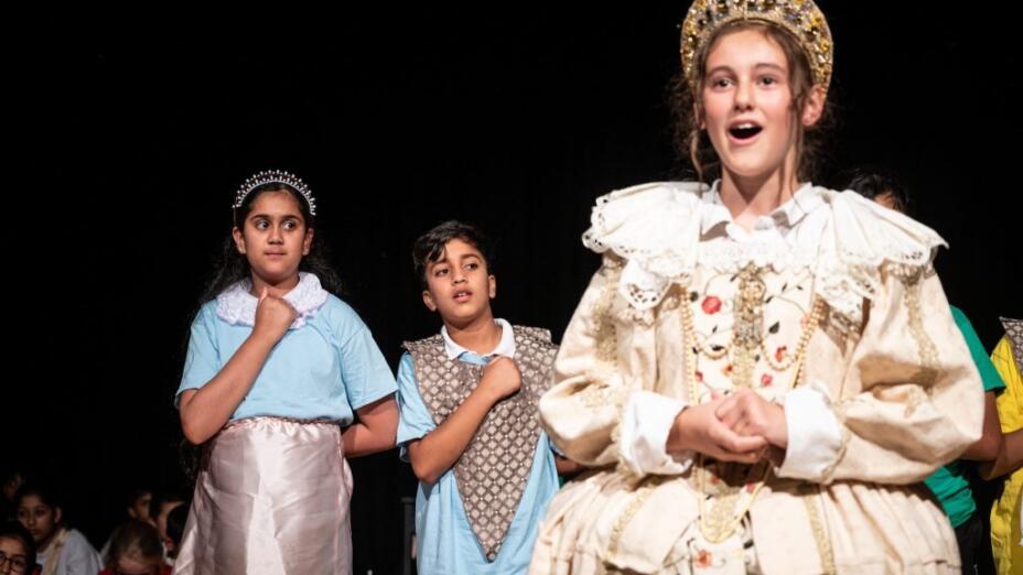 Three school children in period dress take part in an drama-based learning session at Billesley Primary School. Credit: Billesley Primary School.